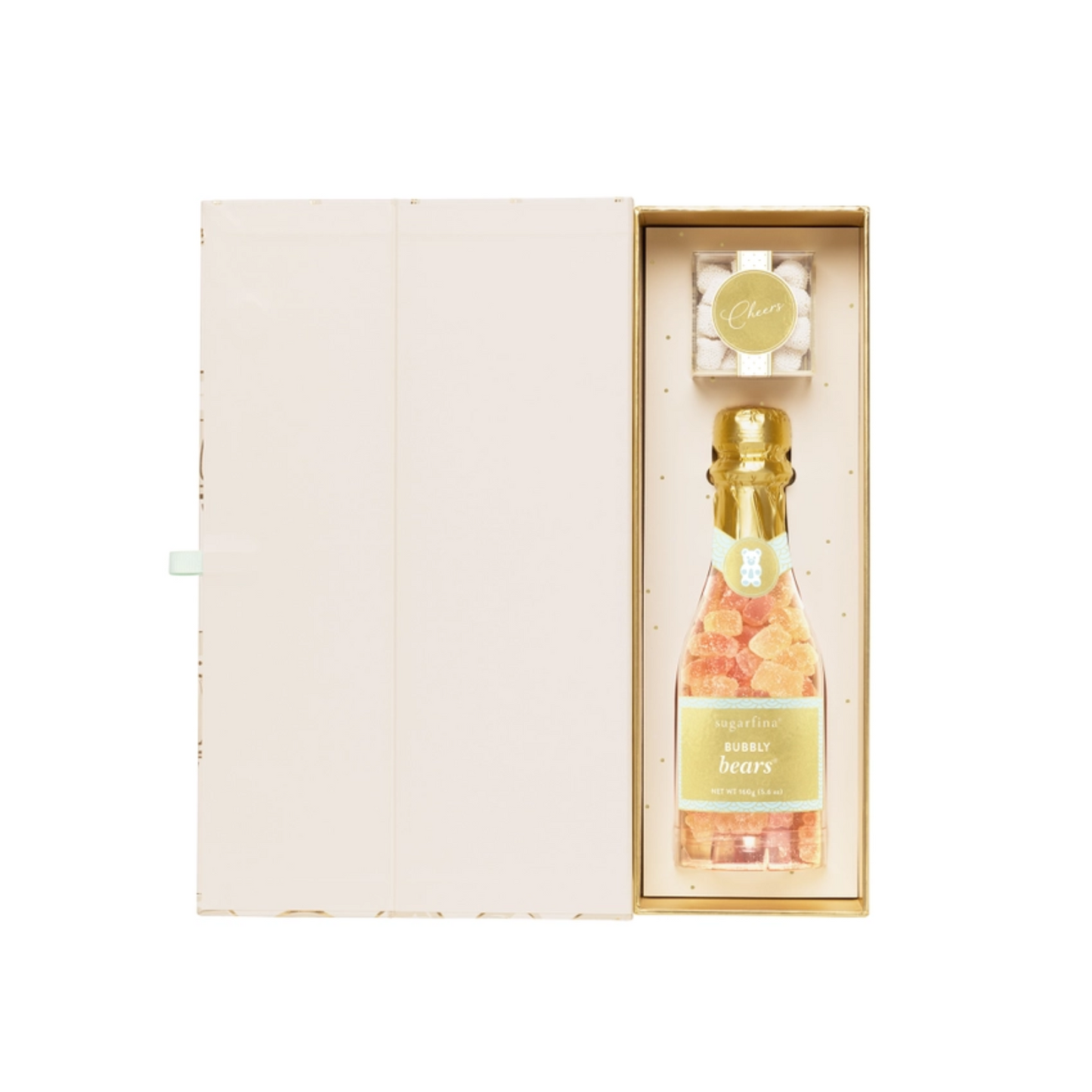 Side view of Sugarfina gift box partially open, revealing champagne bottle-shaped gummy candy inside decorative packaging.