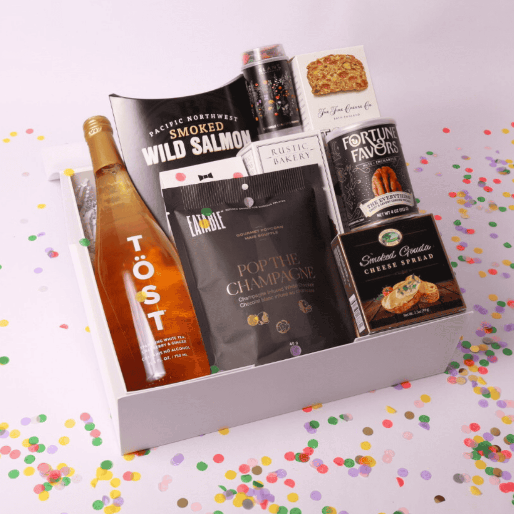 Celebrate in style with our luxurious celebration gift box featuring a bottle of sparkling white tea, pacific northwest smoked salmon, gourmet treats, and elegant pairings—perfect for any occasion, from weddings to corporate gifts.