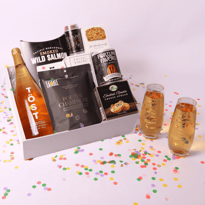 Raise a toast with our deluxe gift set! This elegant pairing of bubbly, artisanal snacks, and stylish glassware is perfect for engagements, New Year's, and milestone celebrations