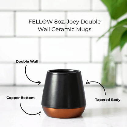 Double-walled Fellow ceramic mug in sleek design, perfect for enjoying hot beverages while keeping hands cool, showcasing its elegant craftsmanship.