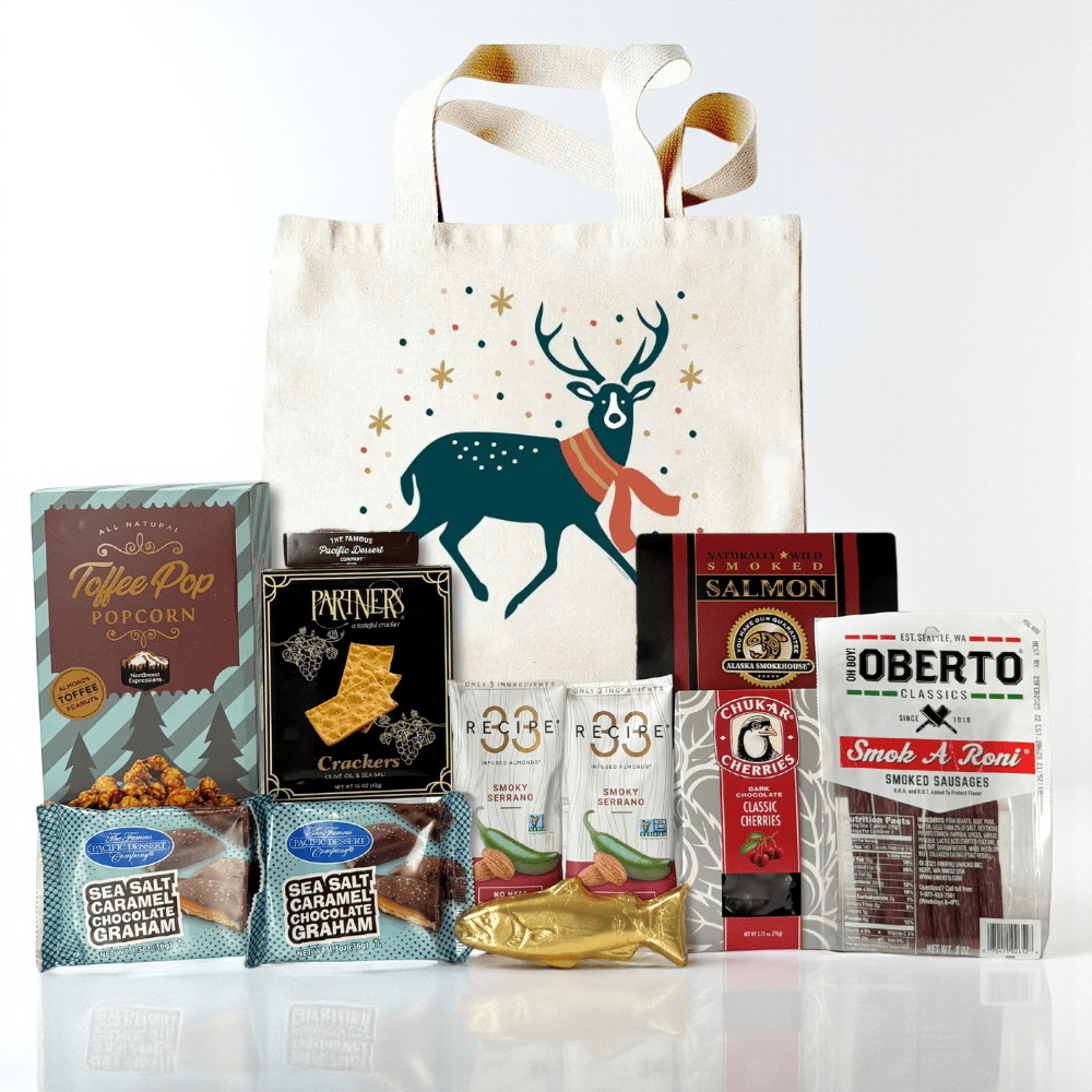 Assorted snacks and a tote bag made in Washington with a deer design on a white background