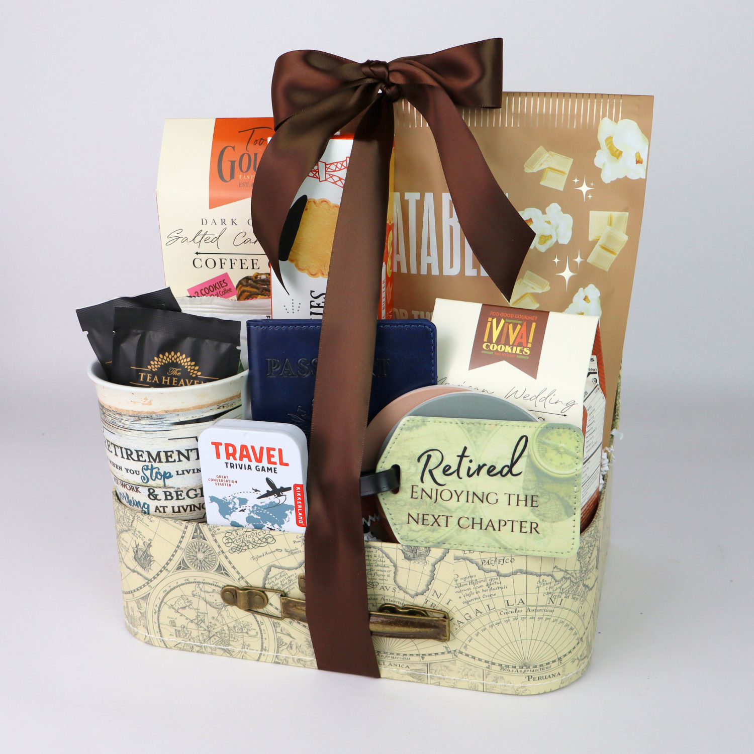 retired Gift basket with travel-themed items and a brown ribbon on a light gray background