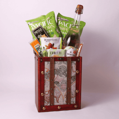 Elegant retirement gift for women in a vintage travel chest, filled with popcorn, wafers, nuts, and sparkling spritz. A unique retirement gift for men or women who enjoy premium treats.