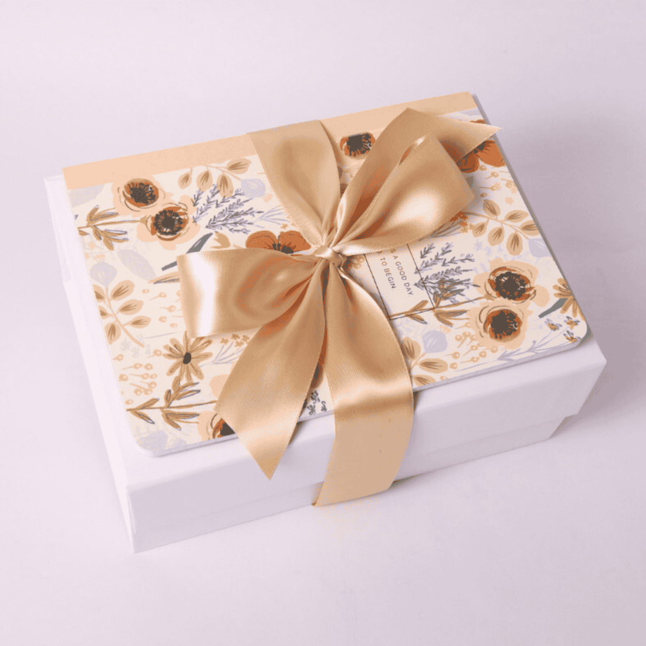 Rose Garden Gift Box with Journal on Top – A beautifully wrapped gift box featuring a floral journal tied with a satin bow, creating an elegant and thoughtful presentation.