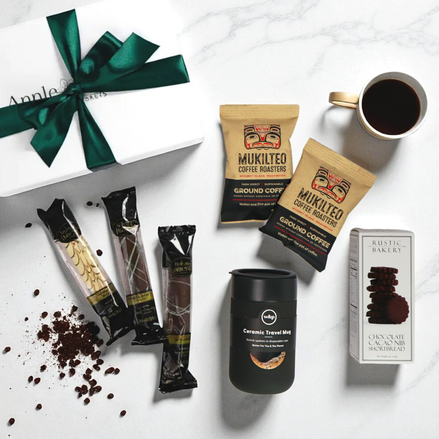 Coffee gift set with green ribbon box, Pacific Northwest coffee, travel tumbler, chocolate cookies, and biscotti.