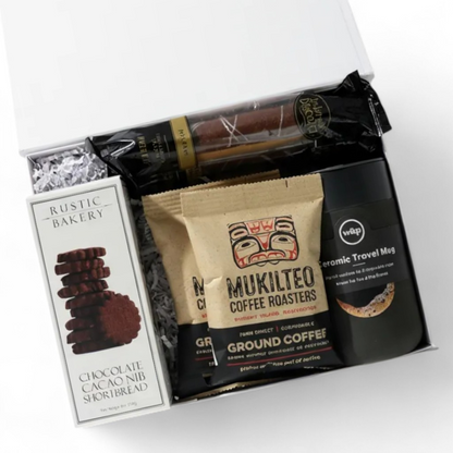 Coffee gift box with Seattle coffee, biscotti, tumbler, and chocolate cookies tied with black ribbon.