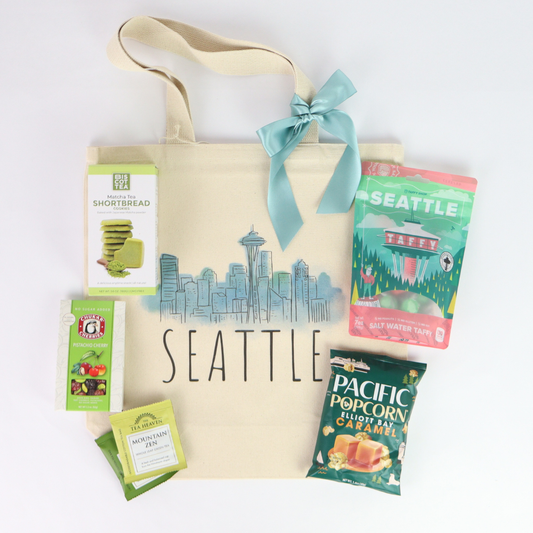 Seattle gift basket tote with Pacific Northwest treats, Seattle taffy, caramel popcorn, tea, and matcha shortbread cookies.
