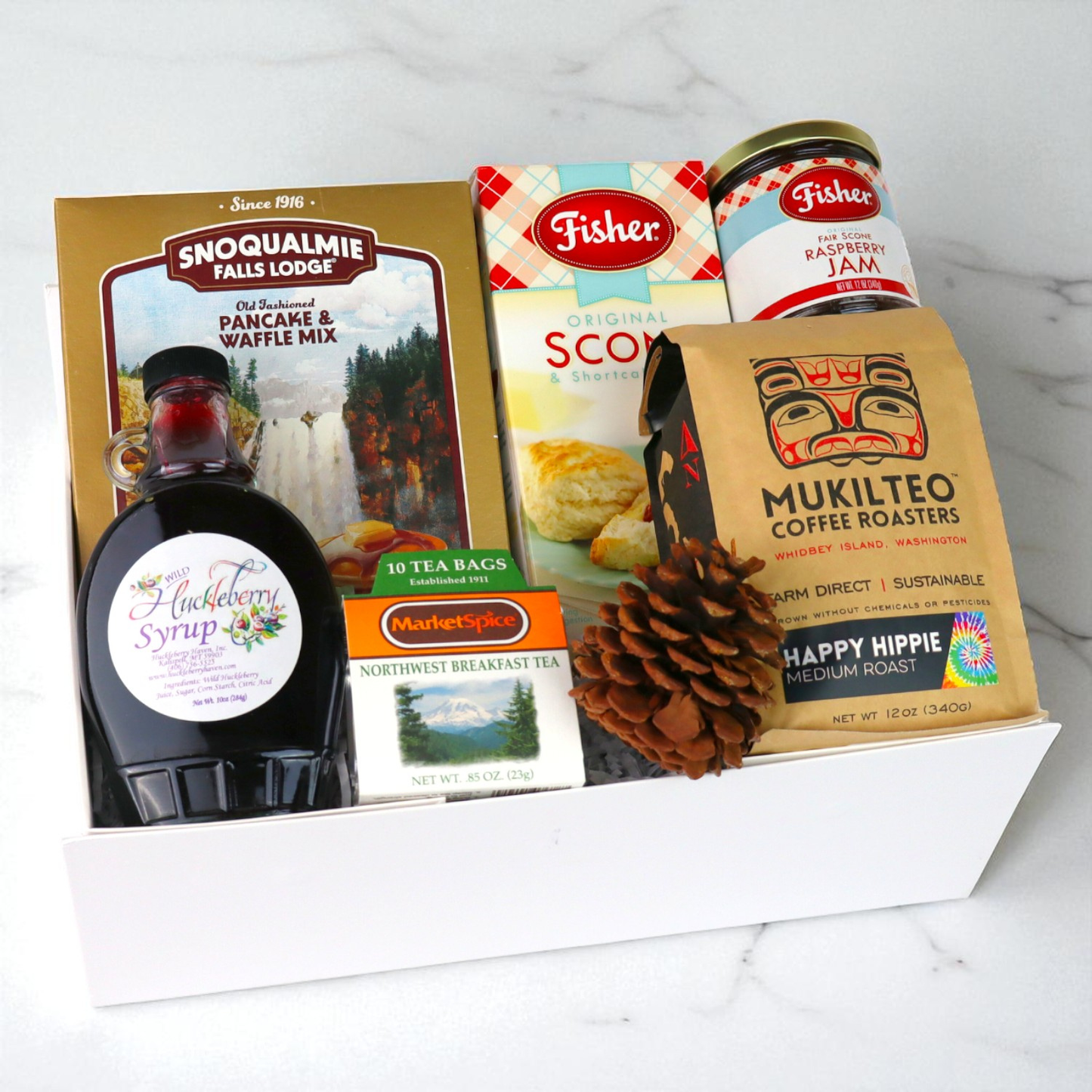 Pacific Northwest breakfast gift set with Seattle tea, pancake mix, hazelnut spread, jam, and nuts arranged neatly for gifting