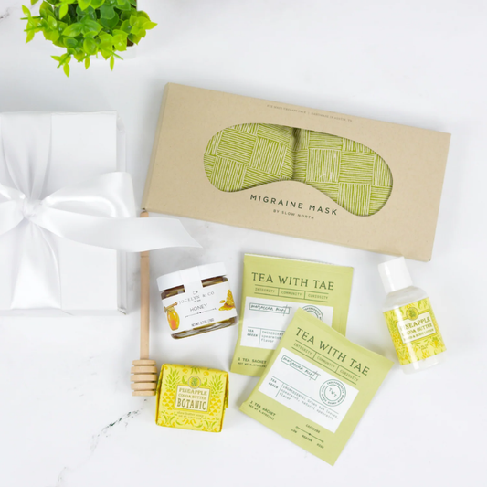 Stress Relief Gift Box with herbal tea sachets, honey, therapeutic eye pillow, and spa essentials in white gift packaging