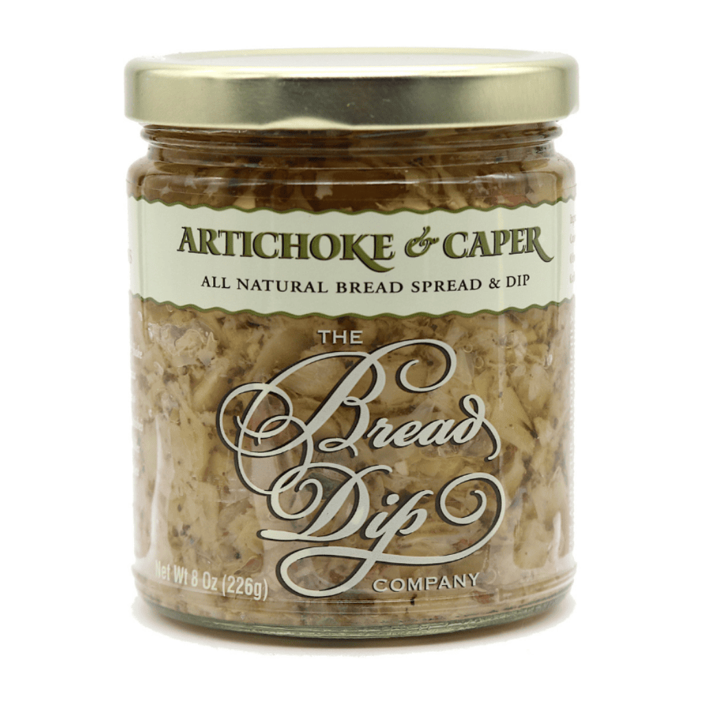 A gourmet jar of artichoke caper dip from The Bread Dip Company, featuring all-natural ingredients in an 8oz glass jar, perfect for bread dipping or charcuterie boards.  Made in the Pacific Northwest