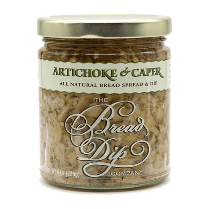 A gourmet jar of artichoke caper dip from The Bread Dip Company, featuring all-natural ingredients in an 8oz glass jar, perfect for bread dipping or charcuterie boards.  Made in the Pacific Northwest