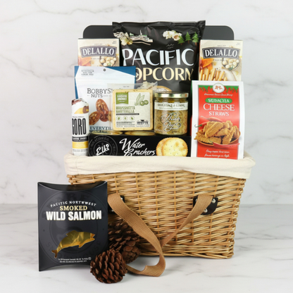 Washington picnic basket filled with gourmet snacks including popcorn, salami, crackers, cheese, and artisan treats, arranged in a classic lidded wicker picnic basket