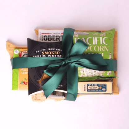 Washington Snack Board gift basket comes with a Washington state shaped bamboo cutting board, smoked salmon, cookies, crackers, chocolate caramels and candied nuts.   Pacific Northwest Gift Baskets
